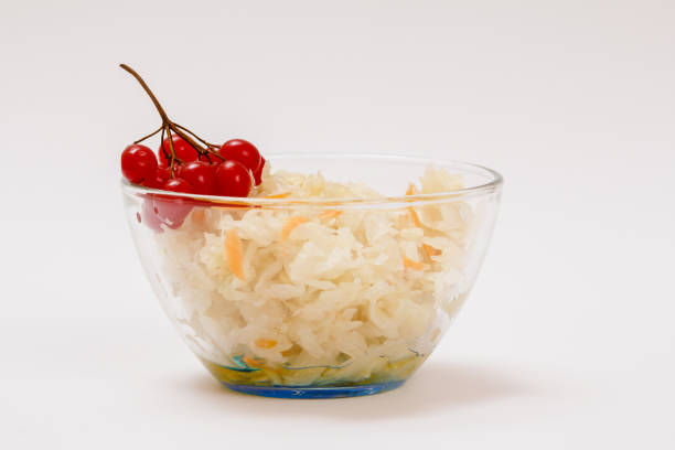 istock Fermented cabbage with herbs and spices in glass bowl on white background 1300282475