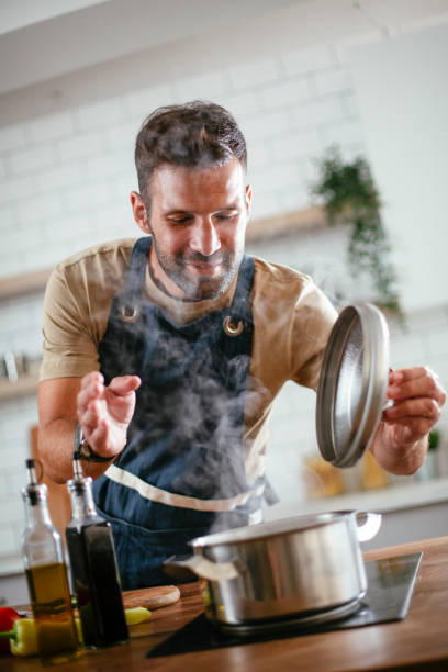 istock Young man preparing delicious food. 1300283966
