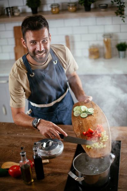 istock Young man preparing delicious food. 1300284151