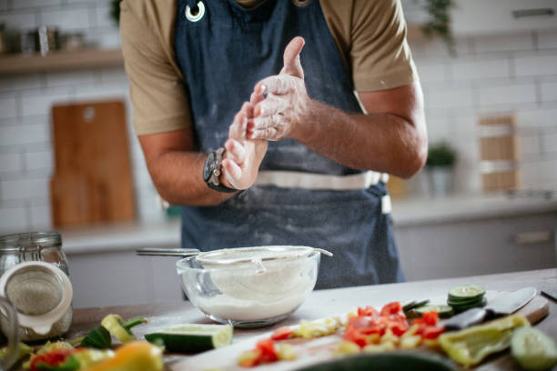 Close up of man baking in the kitchen.