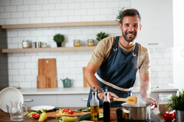 istock Young man preparing delicious food. 1300284917