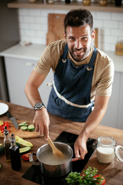 istock Young man preparing delicious food. 1300285523