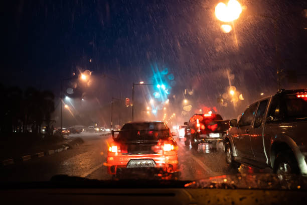 istock Cars driving through rainy at night 1300285916