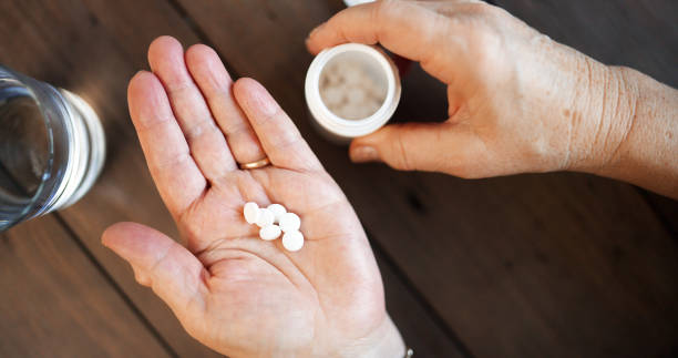 istock Senior woman taking pills 1300285960