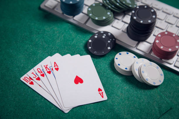 istock Computer keyboard, playing cards and chips. Online casino 1300286757