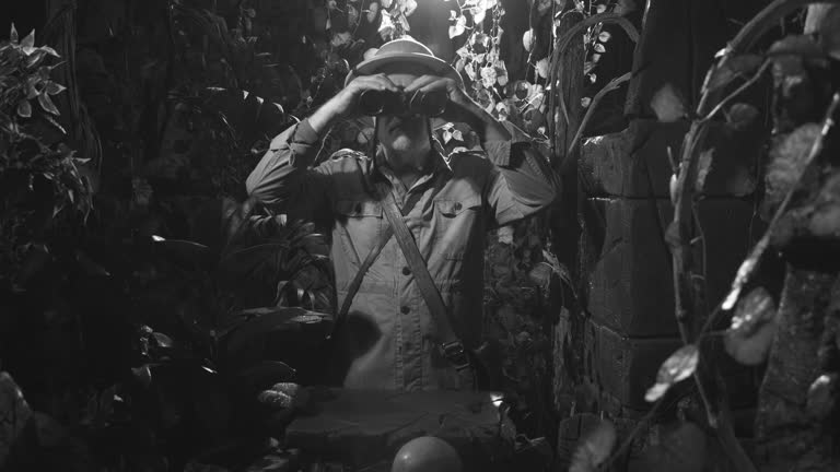 Explorer with binoculars in the jungle