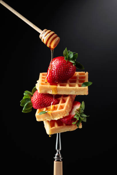 istock Waffles with strawberries and honey. 1300288687