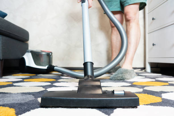 istock a man cleans the carpet at home with a vacuum cleaner 1300288721