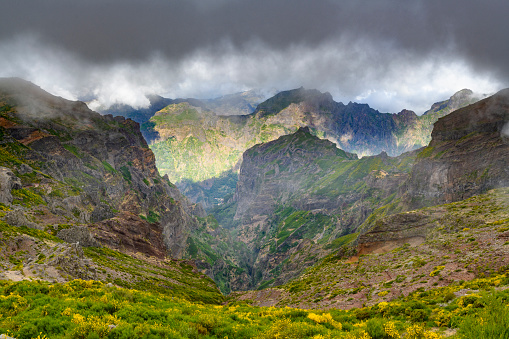 Clouds over the mountains on Madeira island at the Pico do Arieiro on the Vereda do Areeiro - Pico Ruivo, a populair walkway over the highest mountains of the island.