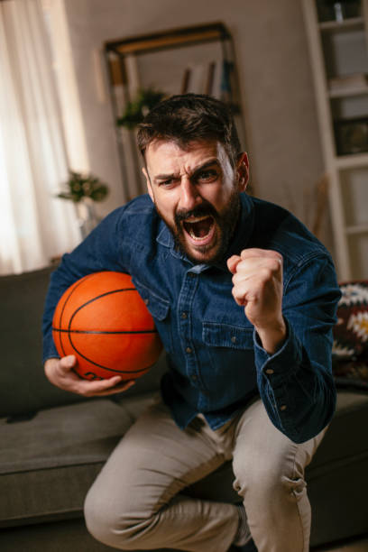 istock Man watching sports game on tv 1300292229