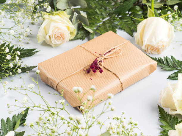 istock Gift box with dried flowers decor with roses around 1300292406