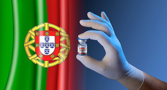 Hand holding vial ampoule vaccine for Corona Virus Covid-19 with flag of Portugal