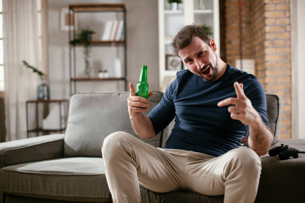 istock Man watching a sports game on tv 1300294039