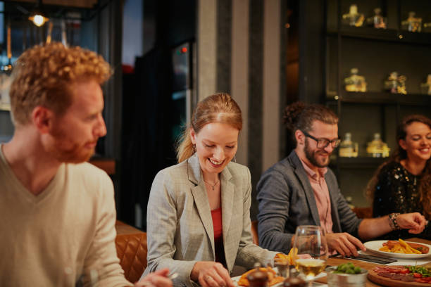 istock Attractive friends sitting in restaurant and having a good time. 1300297547