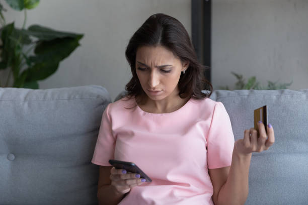 istock Unhappy woman frustrated by error paying online on cell 1300299398