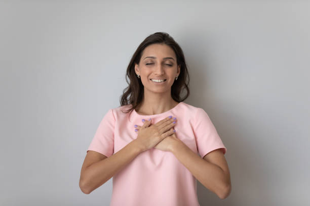 istock Calm ethnic woman on grey background feel thankful 1300299434