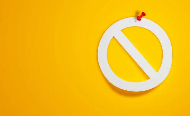 Photo of Pin Paper Forbidden Symbol on Yellow Background