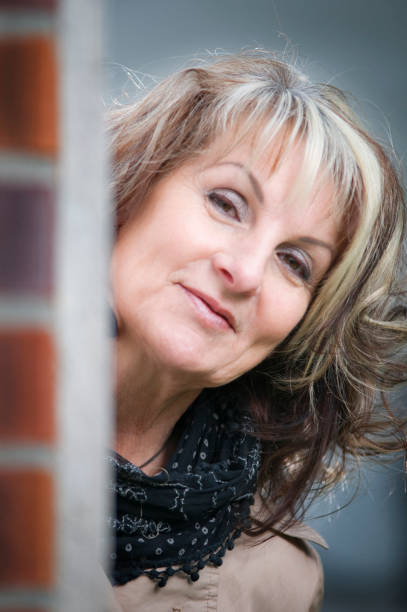 istock Coquettish look behind the wall 1300299634