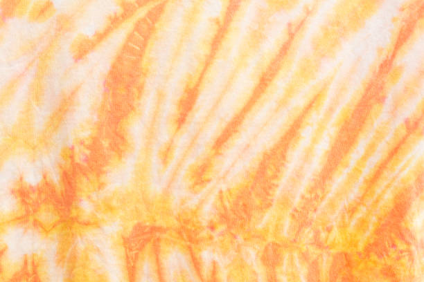 istock Tie-Dye 2 Tone Clouds Close Up Shot fabric texture background Yellow 1300300470