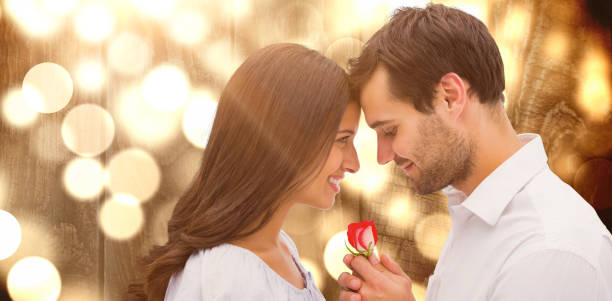 istock Composite image of handsome man offering his girlfriend a rose 1300300865