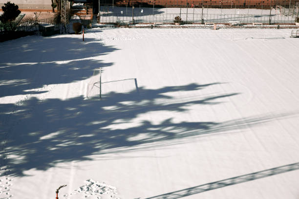 view of a lone goal in a snow-covered soccer field