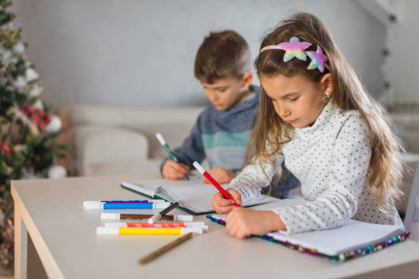 istock Beautiful children homeschooling 1300302409