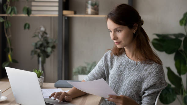 istock Banner view of female work on laptop with documents 1300302710