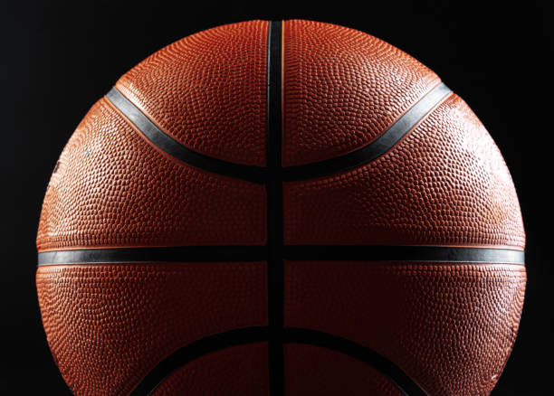 istock Basketball ball close up on dark black background 1300305064