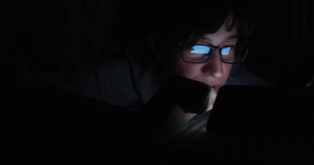 istock Mature woman is using her smartphone in bed 1300306806