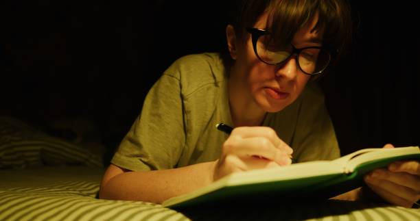 istock Mature woman is writing in the notepad in bed 1300306894