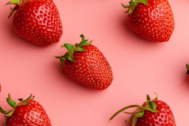 istock Strawberry on pink background. Creative food concept. 1300308629