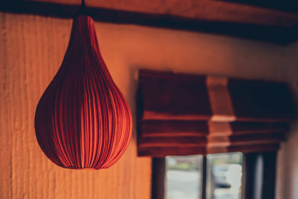 Paper lantern lihgt on blurred dark background in room