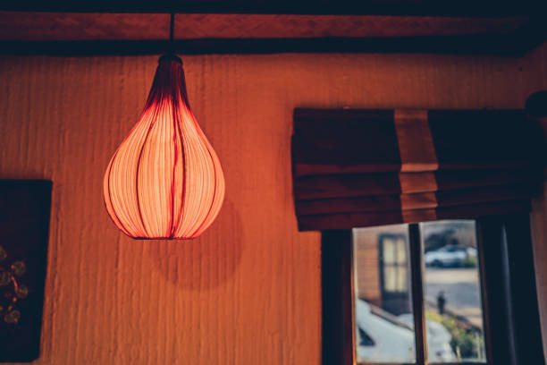 Paper lantern lihgt on blurred dark background in room