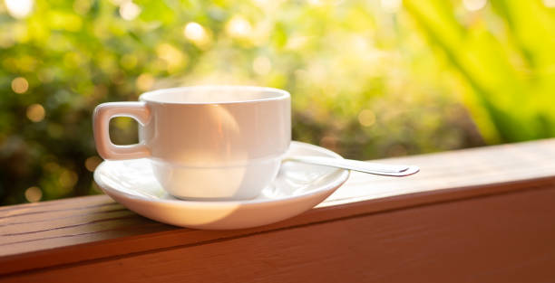 istock Blurred coffee in coffee cup on green nature bokeh background on morning, caffeine beverage for fresh lifestyle, close up cup and steam water on light of sunny wallpaper, beautiful photo for graphic 1300312877