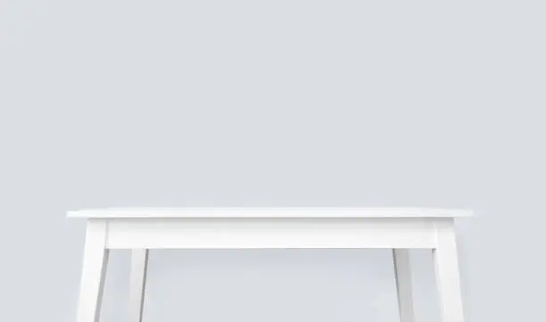 Image representing white table mockup in office space. Clean empty desk surface. Copy space above the table.