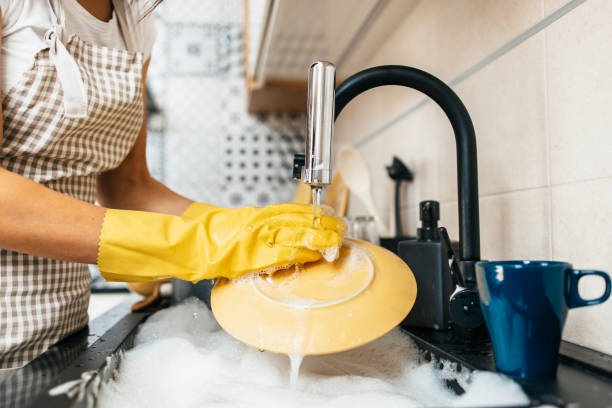 istock Housewife dish washing 1300313582