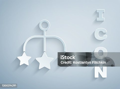 istock Paper cut Baby crib hanging toys icon isolated on grey background. Baby bed carousel. Paper art style. Vector 1300314291