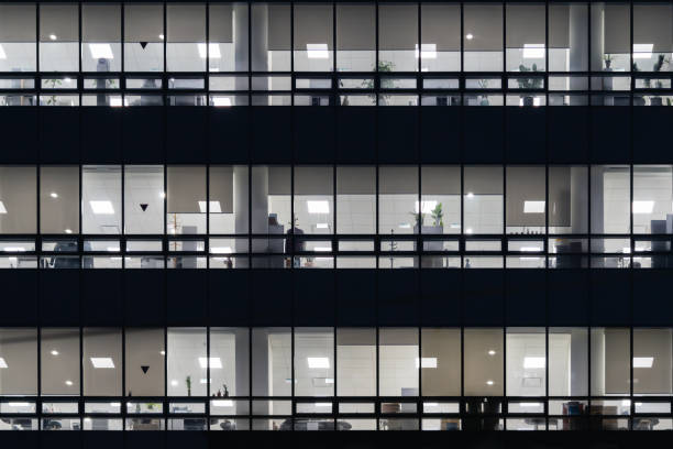 istock The windows of a modern office building with lights inside 1300314310