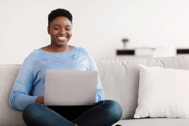 istock Black woman working on computer, looking for a job 1300315965