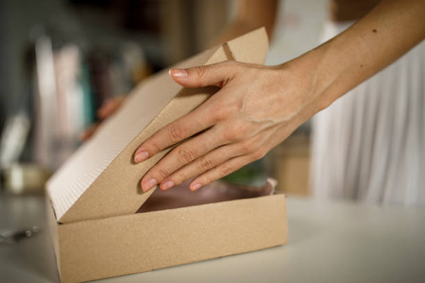 istock Closing a box after finishing packing customer's order 1300316329