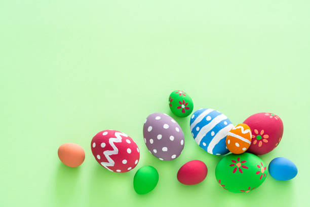 istock Overhead view of colorful Easter eggs with on green background. Copy space 1300317783