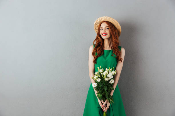 istock Redhead young woman with flowers. 1300318065