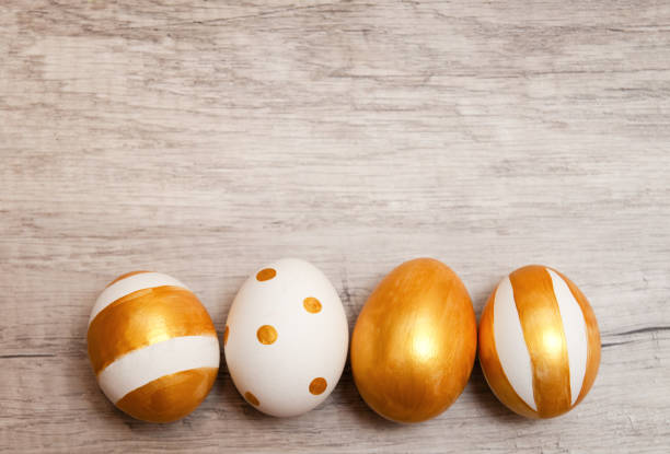 istock Colorful golden bright handmade painted easter eggs on a wood background. 1300319317
