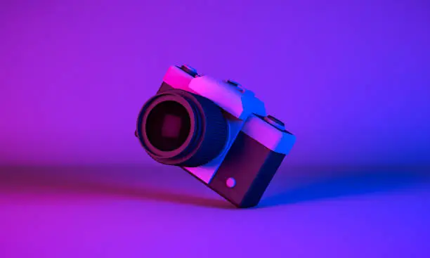 3D Rendering, Realistic mock up 
tilted vintage camera in neon blue purple colors lighting and background.