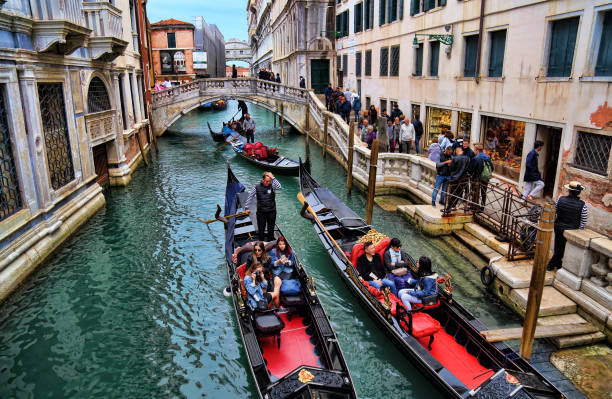 gondolas with tourists in venice, italy - men gondolier people activity imagens e fotografias de stock