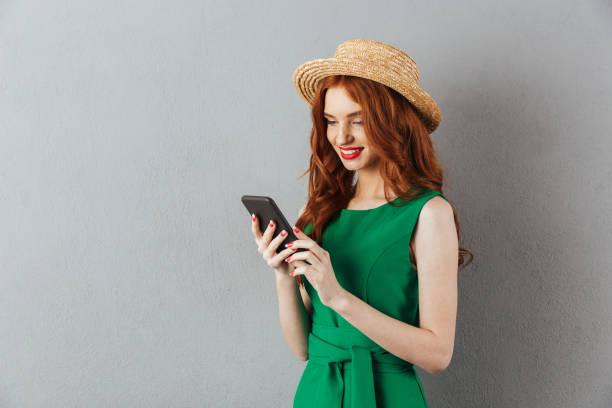 istock Redhead young cheerful woman chatting by mobile phone. 1300320355