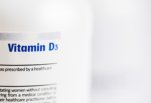 Pill bottle labeled Vitamin D3. Vitamin D deficiency appears to be correlated with worse outcomes of Covid-19, although definitive proof has been elusive.