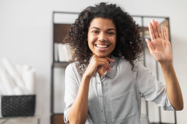 istock African American office worker waving at camera 1300321526