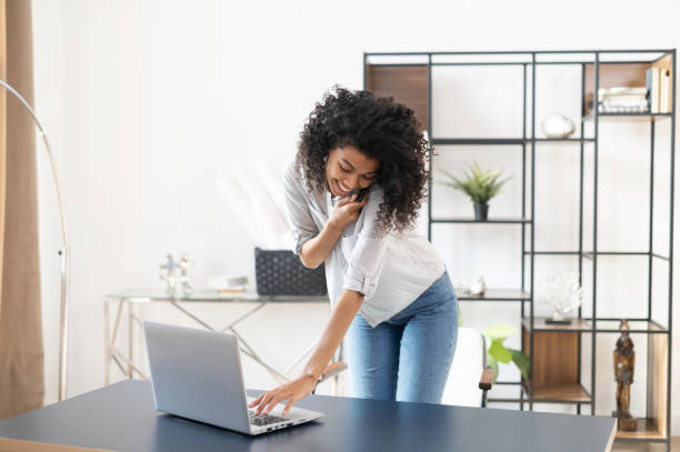 istock African American woman using laptop and cellphone 1300321595