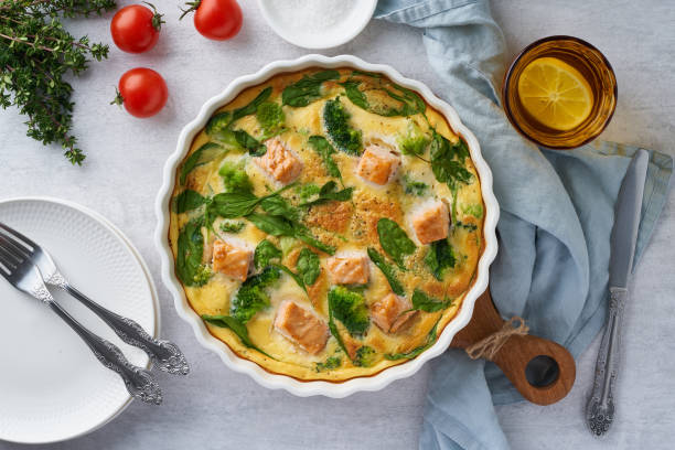 Egg-based frittata, omelette with salmon, broccoli and spinach, top view Egg-based frittata, omelette with salmon, broccoli and spinach. Italian dish, crustless quiche with eggs, fish and vegetables. Mediterranean ketogenic healthy diet. Top view frittata stock pictures, royalty-free photos & images